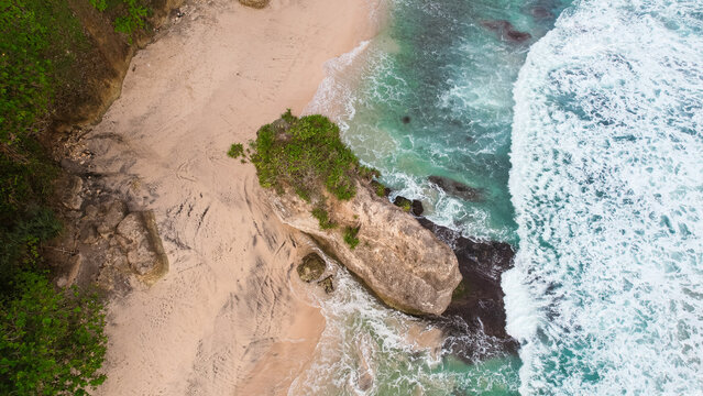 Aerial view of Lumbung Beach with iconic large rock formation in Tulungagung, East Java, Indonesia.