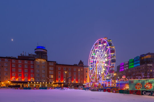 Quebec City, Quebec, Canada, February 7, 2026 - The winter festival Carnaval de Qu&eacute;bec great wheel illuminated at night, with the Ch&acirc;teau Laurier hotel and other buildings in the background