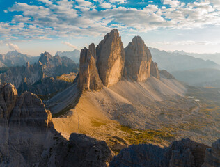 Obraz premium Aerial view of Tre Cime di Lavaredo showcasing the dramatic limestone peaks rising above alpine terrain. One of the most iconic landscapes in the Dolomites and the Italian Alp