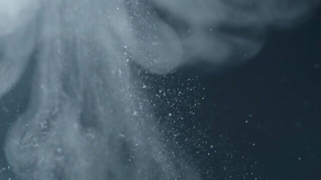 Microscopic Condensation Detail An extreme close-up of warm, moist air instantly condensing into a swirling cloud of fog and tiny ice crystals upon contact with intensely cold, still air.