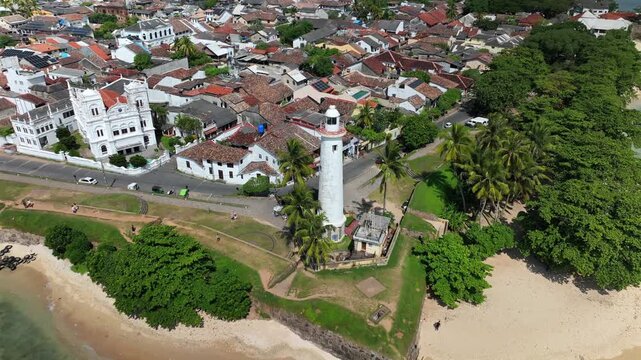 Drone footage of Galle Fort, coastal heritage site in Sri Lanka. Aerial views display historic architecture, lighthouse, ramparts, and tropical coastline for travel, culture, and history themes.
