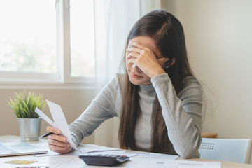 Financial owe, hand of asian woman sitting, holding credit card, stressed by calculate expense from...