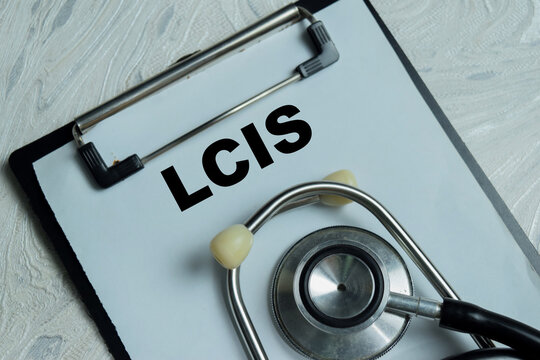 Concept of LCIS - Lobular Carcinoma In Situ write on clipboard isolated on Wooden Table.