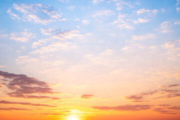 Sunset or sunrise sky with a vibrant gradient of orange, gold, and soft blue. Clear atmosphere with wispy clouds. Peaceful, natural light background. hope, freedom, new day and inspirational Concepts