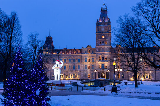 Quebec City, Quebec, Canada, February 7, 2026 - Annual winter festival giant Bonhomme Carnaval figure in front of the 1886 Parliament illuminated building at night