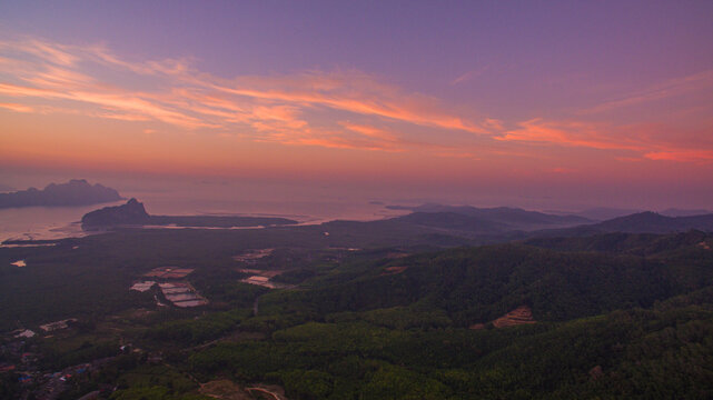 Aerial view of beautiful sunrise at Samet Nangshe viewpoint, islands, valley hills, and tropical green forest trees at sunrise with archipelago in Andaman sea in Phang Nga Bay. sweet sky