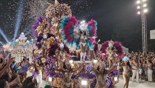 Vibrant Carnival Performers Dancing in Colorful Costumes Under Bright Lights