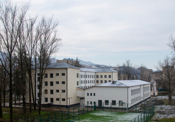 The first snow has fallen. School yard and stadium