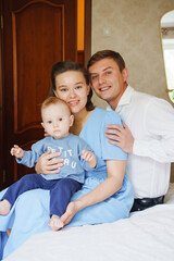 Fototapeta premium Family portrait in a cozy home setting with baby