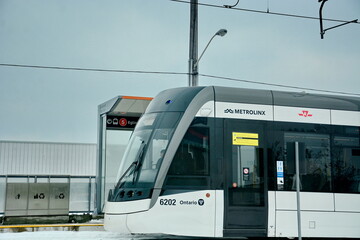 Naklejka premium Toronto, Ontario, Canada, February 6, 2026: A Metrolinx Eglinton Crosstown LRT test train makes its way along the transit line in Scarborough. This LRT line, after waiting for years to open, is now sc