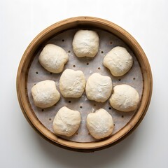 Fototapeta premium Steamed buns in a bamboo steamer basket on a white background.