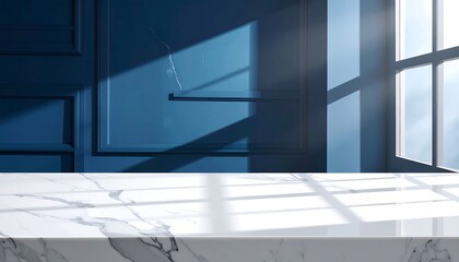 Interior shot; white marble countertop with shadows falling on it, set against a panelled blue wall near a window