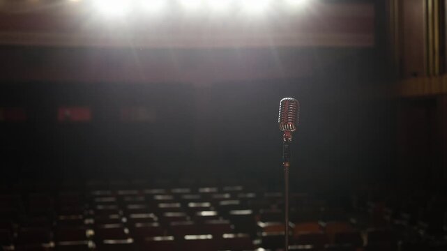 Wide View of Concert Hall with Stage Lights, Chairs and Vintage Microphone Foreground