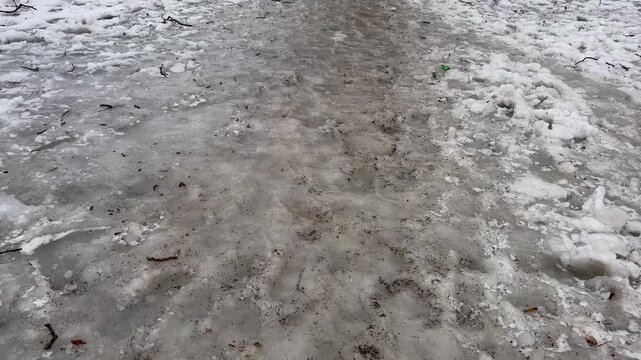 The road was covered with ice after the rain in the frost.