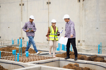 Reinforced concrete structures. Man and woman construction worker working together at workplace. Group of professional construction engineering people in hardhat safety helmet. Unity and teamwork