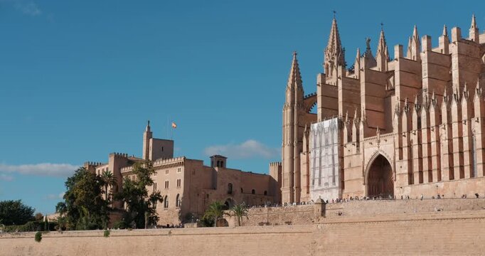 Palma Cathedral and the Royal Palace of Almudaina in Majorca, Spain. Sunny day view of these historic architectural landmarks.