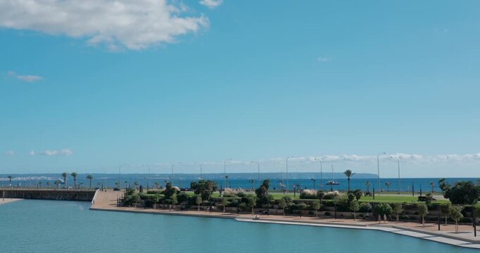 Sunny view of Palma de Mallorca, calm water reflecting the sky, and the Mediterranean Sea, view from Almudaina area.