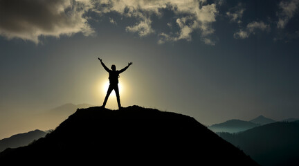 Explorer celebrating achievement on high mountain ridge