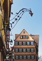 Ornate Wrought Iron Sign Bracket and Lantern with Historic Houses in Tubingen