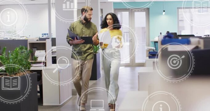 Woman and man walking while using tablet and papers reviewing plan tech icons rising camera zooming