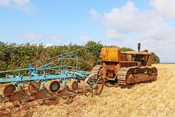 Vintage tractor ploughing a field