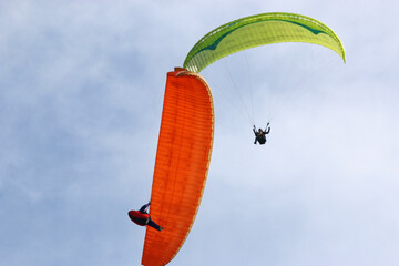Paragliders flying in a blue sky	