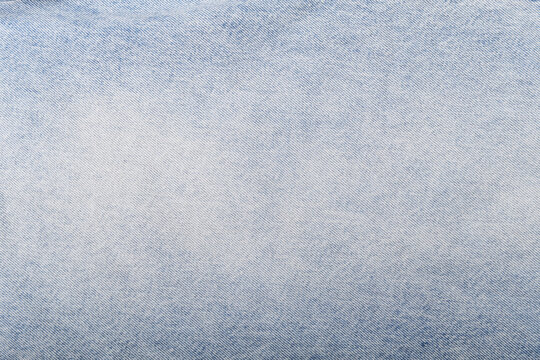 Light blue denim texture with a soft gradient and fine weave.