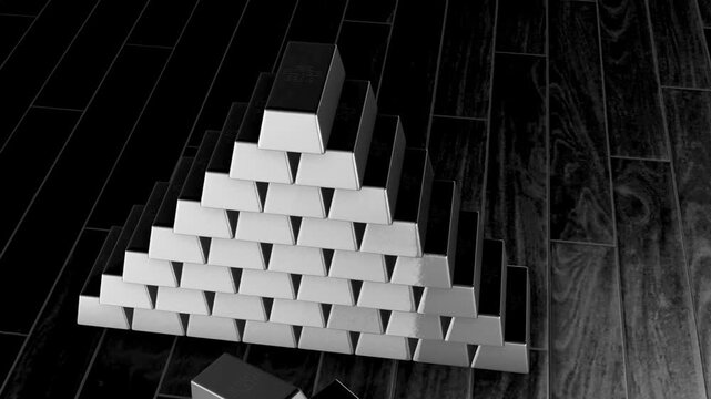 Silver bars stacked on a wooden floor