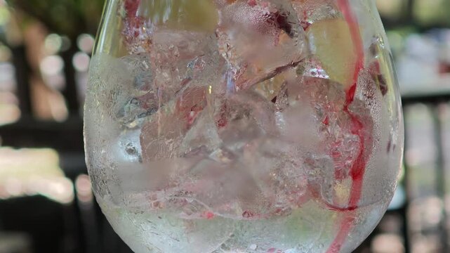 Pour the red berry fruit tea into a glass filled with ice.