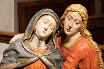 Fotobehang Jezus Christus VIGEVANO, ITALY - JANUARY 18, 2026: The detail of carved sculptural goroup - St. John and mother Mary - Lementation over death Chrfist in the Cathedral of St. Ambrose by unknown artist (1500 - 1549).   © Renáta Sedmáková