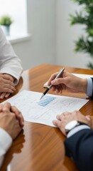 Business meeting with document signing.