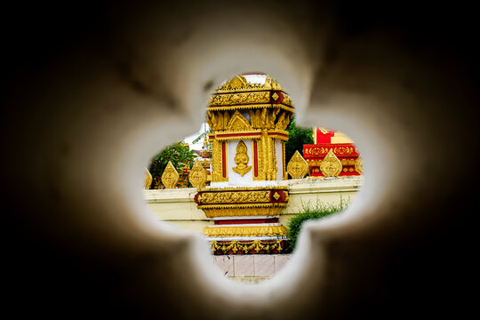 temple through a hole, vientiane, laos