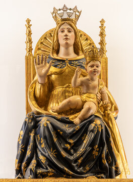 BUSTO ARSIZIO, ITALY - JANUARY 19, 2026: The carved polychrome staue of Madonna on the throne in the church Santuario di Santa Maria di Piazza by Fabrizio De Magistris (1595-1602)