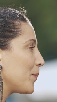 Woman at the outdoors party drinking and having a talk