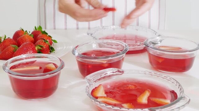 Sliced strawberries with the dissolved gelatin mixture. High quality 4k footage