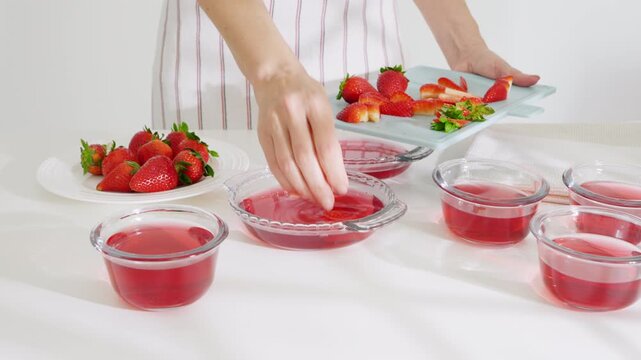 Sliced strawberries with the dissolved gelatin mixture. High quality 4k footage