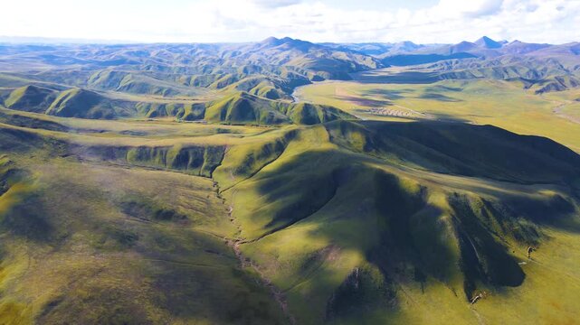 Aerial View of Rolling Mountains and Green Grassland Plateau