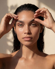 Obraz premium Sunlit dewy skin beauty portrait with freckles and face yoga brow lift gesture 