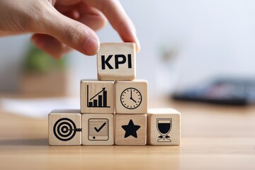 Professional hand placing KPI wooden cube on top of pyramid