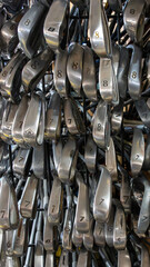 Pile of golf putters in a flea market