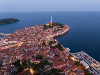 Aerial view of Rovinj old town just before sunrise, with soft twilight tones and calm Adriatic waters creating a peaceful pre-dawn coastal atmosphere