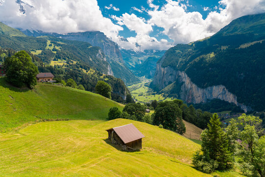 Colorful summer landscape of Lauterbrunnen Valley with green meadows and blue sky, Switzerland