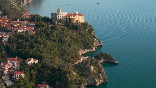 Italy Duino Castle drone 4K of white cliffs and scenic bays view in Trieste Gulf cinematic aerial panorama of historic fortress and Adriatic sea mediterranean aesthetics travel video