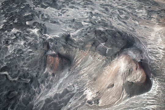 Patterns of solidified lava on volcanic surface