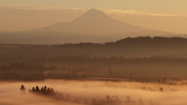 The scenic Mount Hood rises from the forested landscape of northern Oregon. This iconic Pacific Northwest mountain is part of the Cascade Mountain Range.