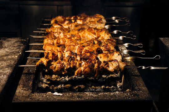 Grilled skewers over open flame at street market