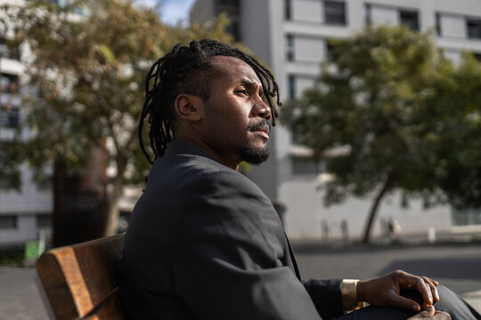 Businessman with dreadlocks enjoying cityscape