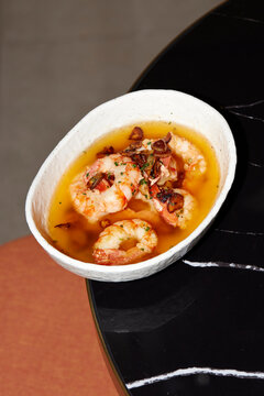 Shrimp dish with garlic and herbs in a white bowl
