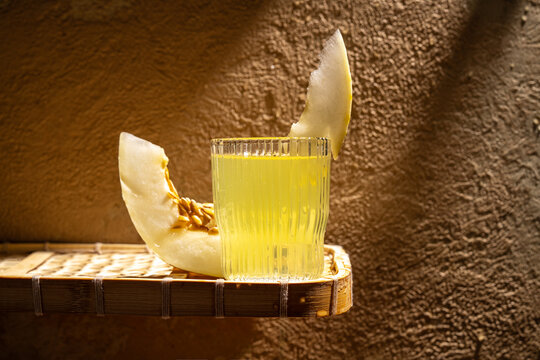Refreshing melon juice with fresh melon slices