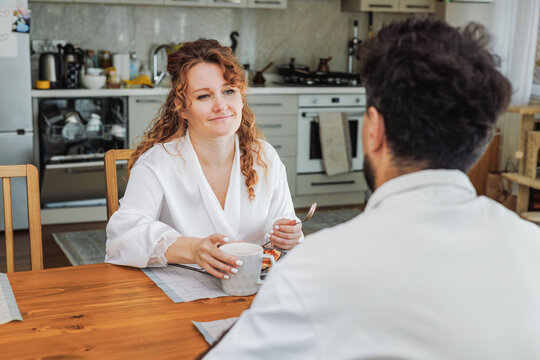 Couple enjoying breakfast in a cozy kitchen